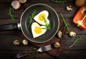 Valentines breakfast in heart shaped cast iron pan of two raw eggs and yolks
