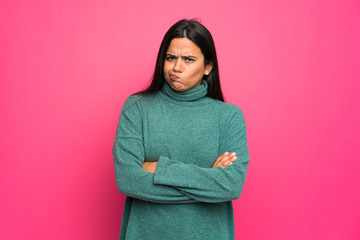 Fototapeta premium Young Colombian girl with green sweater feeling upset