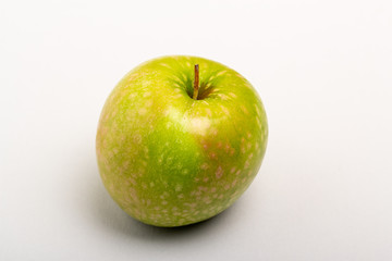 Two green ripe apple close up on a white background