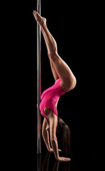 Obraz na płótnie Canvas Pole dancer dancing on a pylone