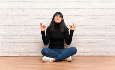 Woman sitting on the floor in zen pose