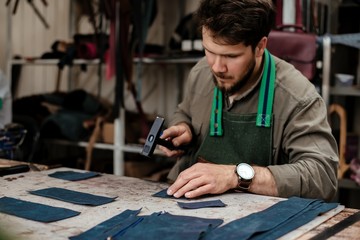 A master works with genuine leather making exclusive things