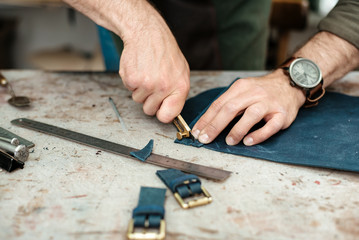 A master works with genuine leather making exclusive things