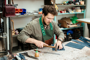 A master works with genuine leather making exclusive things