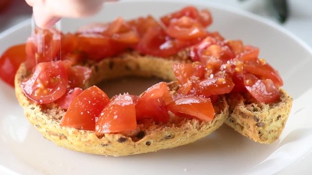 Apulian traditional summer dish. Eat with Tomatoes, Olive Oil and Origano. Italian starter friselle. Classical frisella with tomato, salt, oregano and olive oil. Tipical apulian still-life of healthy 