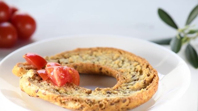 Apulian traditional summer dish. Eat with Tomatoes, Olive Oil and Origano. Italian starter friselle. Classical frisella with tomato, salt, oregano and olive oil. Tipical apulian still-life of healthy 