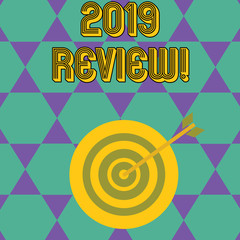 Handwriting text 2019 Review. Conceptual photo remembering past year events main actions or good shows Color Dart Board in Concentric Style with Arrow Hitting the Center Bulls Eye
