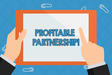 Conceptual hand writing showing Profitable Partnership. Concept meaning Creating an environment for mutual growth and success Businessman Hand Holding and Pointing Colorful Tablet Screen
