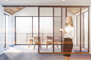 Blonde woman in dining room interior