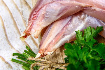 close up raw rabbit on a wooden background - top view. Concept of Dietary Nutrition