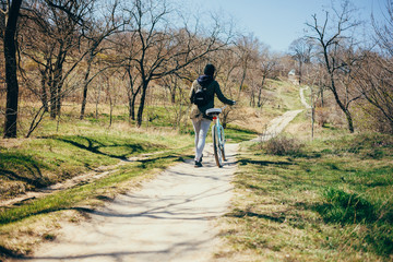 Cycling in nature. Rear view young woman