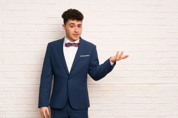 Man in suit and bow tie making doubts gesture