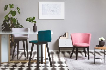 Colorful velvet chairs in fashionable grey living room interior with glass table