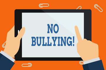 Word writing text No Bullying. Business photo showcasing stop aggressive behavior among children power imbalance Hand Holding Pointing Touching Blank Rectangular Color Tablet White Screen