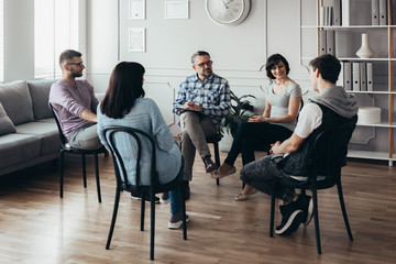 Group therapy session for young men and women