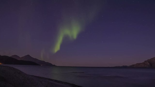 Northern light (aurora borealis) in a fjord after dawn 4K