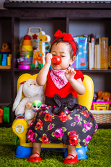 A cute 2 years old baby play by herself inside her house