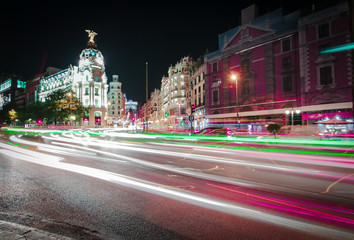 Fototapeta na wymiar Rays of traffic lights on Gran via street, main shopping street in Madrid at night. Spain, Europe