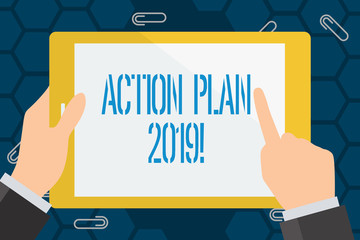 Conceptual hand writing showing Action Plan 2019. Concept meaning proposed strategy or course of actions for current year Businessman Hand Holding and Pointing Colorful Tablet Screen