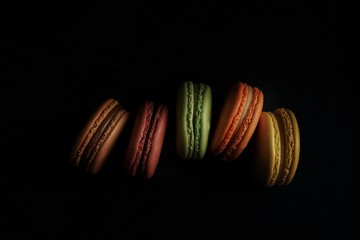 bright macaroons on black background