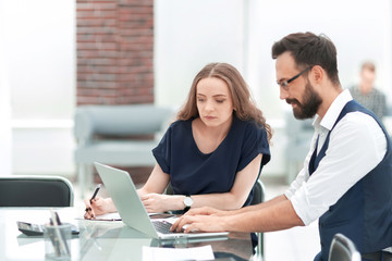 business colleagues using a laptop in the workplace.