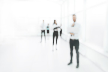blurred image of employees standing in the office lobby