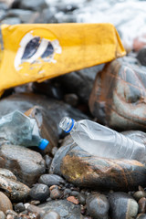 Stop polluting oceans, plastic bottles on a beach  with washed up plastic traffic cone