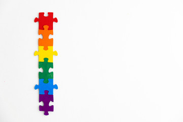 concept of equality of different sexual segregations: LGBT pride flag, built from a puzzle, short focus, top view