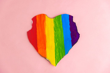 Concept - harassment of the freedom of the LGBT community: a burned and torn rainbow heart, short focus