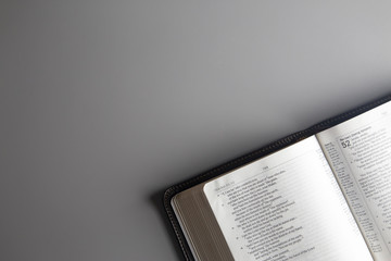 Single Bible Open on a Gray Background