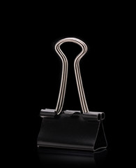 Black Paper clip isolated on black background