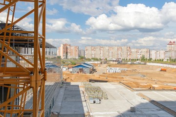 construction site, machinery, building materials, against the backdrop of the cityscape