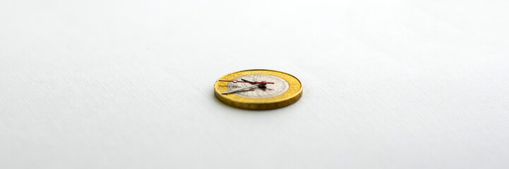 time and money, concept: second, hour and minute hands on a coin of 2 Belarusian rubles, on a light background, short focus