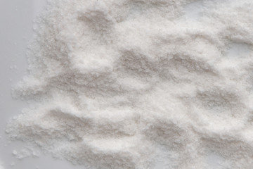 mineral diet: a small pile of sea iodized edible salt on a plate, short focus