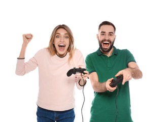 Emotional couple playing video games with controllers isolated on white © New Africa