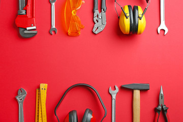 Flat lay composition with construction tools on color background, space for text
