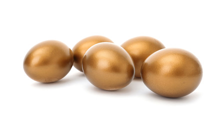 Many shiny golden eggs on white background