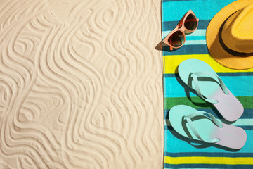 Flat lay composition with beach objects and space for text on sand