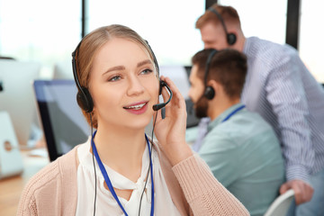 Technical support operator with colleagues in office