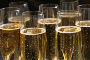 Glasses of champagne on dark background, closeup