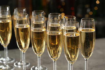 Many glasses of champagne on blurred background, closeup