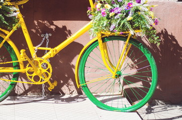Fototapeta na wymiar retro yellow green bicycle in tenerife town Canarian Street with flowers