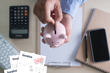 Close-up man work Invoice Bill Paid Payment  At Office Invoice savings, finances bill