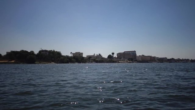 LUXOR, EGYPT, view of the shore from a boat on the Nile River in Luxor, Egypt