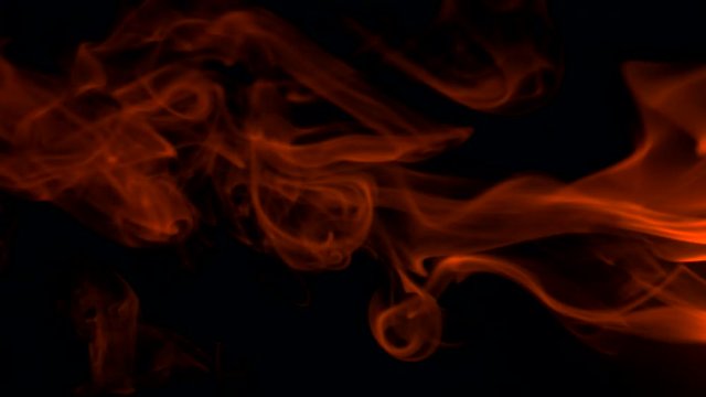 Vertical video screensaver - Fiery red smoke billow rising swirl up, isolated on black background. Colored smoke blowing from the right side. Closeup, isolated on black background.