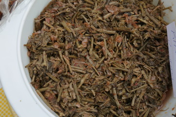 green tea leaves in bowl on wooden table