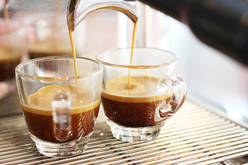 Black coffee being brewed by the machine