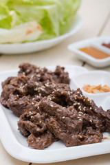 beef bulgogi with fried garlic and iceberg lettuce