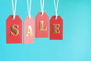 inscription sale in gold letters on red labels on a blue background