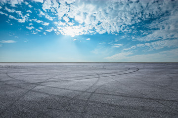 Empty asphalt race track ground and beautiful sky clouds